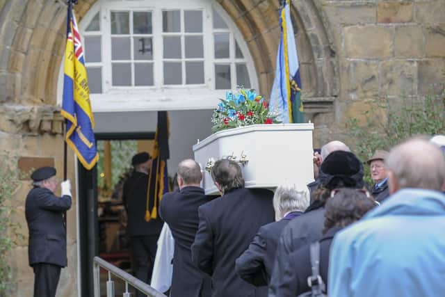 Mourners follow the coffin into Beauchief Abbey