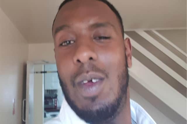 One of the new photos of murder suspect Abdi Ali, showing him with his front tooth missing