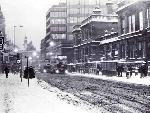 Buses struggle through the snow and slush in Leopold Street in 1986.