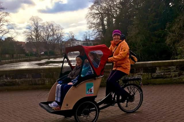 Clare and her aunt Margaret enjoying a ride as passengers in a trishaw (Picture: Claire Rawlings)
