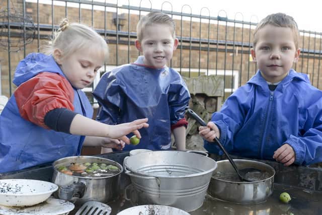 Youngsters boiling a lovely Vegetable soup in the mud kitchen