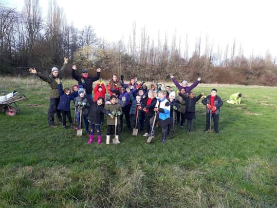 Children from Pipworth Community Primary School tree planting at Manor Playing Fields.