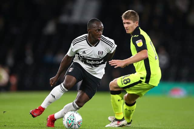 Fulham's Neeskens Kebano (left) and Exeter City's Jimmy Oates battle for the ball during the Carabao Cup, second round match at Craven Cottage, London.  Nigel French/PA Wire.