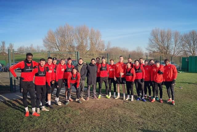 Bring Me the Horizon star Mat Nicholls with Rotherham United players and staff