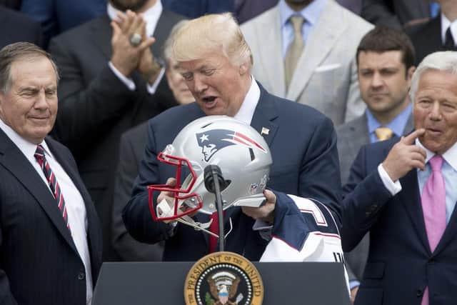 United States President Donald Trump, flanked by New England Patriots head coach Bill Belichick (left) and owner Robert Kraft.