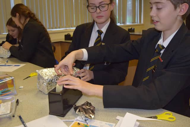 Year 8 pupils learning how to make a flotation device