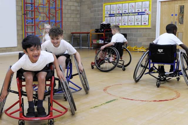 Pictured are Class Y3M trying Wheelchair Basketball