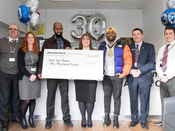 Saeed Brasab accepting the cheque for Unity Gym Project with Lord Mayor Magid Magid