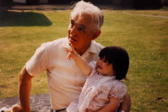 Gilbert with his first grandchild Abigail in 1992.