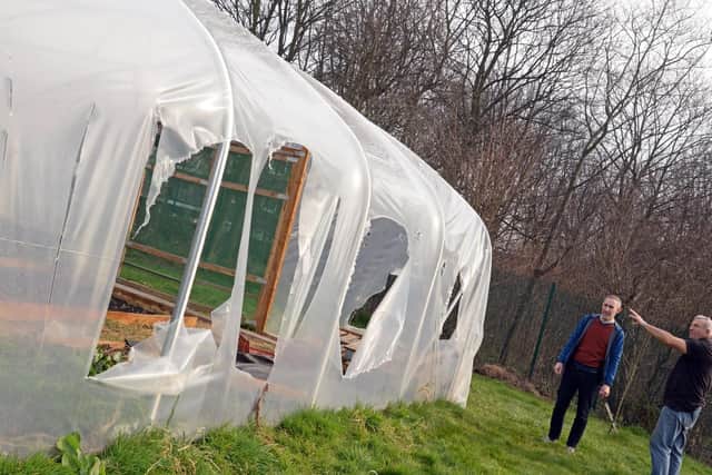 Volunteers James Starky and Tony Slack, pictured, surveying the damage to the Polytunnel. Picture: Marie Caley NDFP-28-02-19-HerdingsCommunity-3