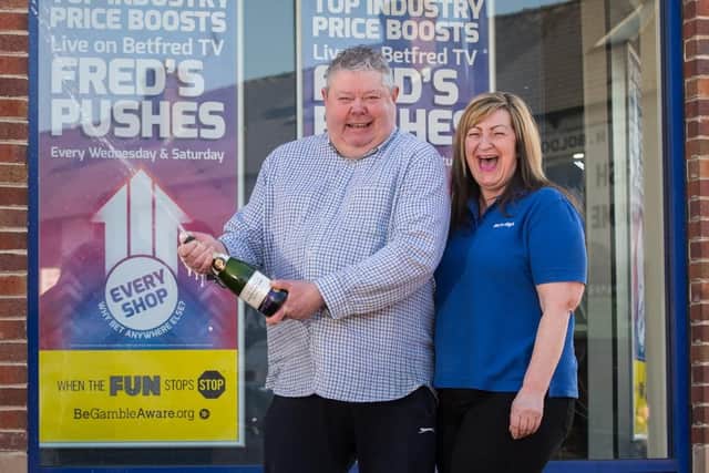 Glyn outside the Betfred branch in Woodseats, where he bought his winning ticket, with shop manager Louise Parkin (pic: Jon Parker Lee)