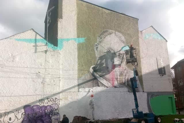 Jo Peel, in the cherry picker, at work on her new mural on Howard Street in Sheffield city centre