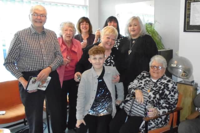 Retiring Mosborough hairdresser Marie Andrews surrounded by friends, staff, customers and husband Philip, left, on her final day in the salon