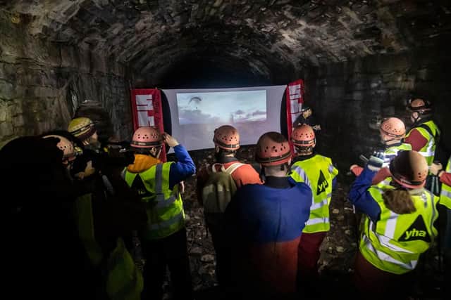 People watch a film while Urban Caving as an underground network of rivers are opened up to the public for an audio-visual spectacular during the Sheffield Adventure Film Festival. Picture: Danny Lawson/PA Wire.