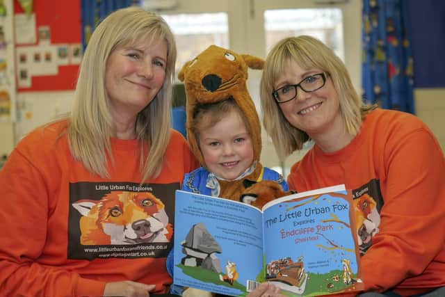 Isla Hill (6) listens as Helen Stokes (left) and Kathryn Herold read The Little Urban Fox at Waterthorpe Nursery Infant School