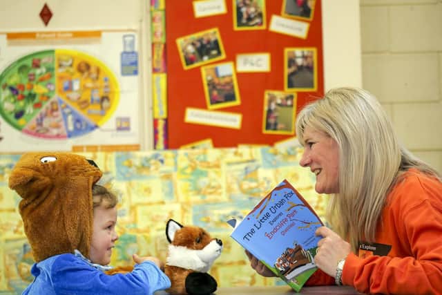 Isla Hill (6) listens as Helen Stokes reads The Little Urban Fox at Waterthorpe Nursery Infant School. Picture Scott Merrylees