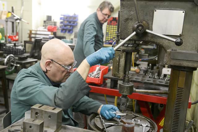 OSL Cutting Technologies machinists Mark Atkinson, left, and Alan Jackson, on the shop floor.