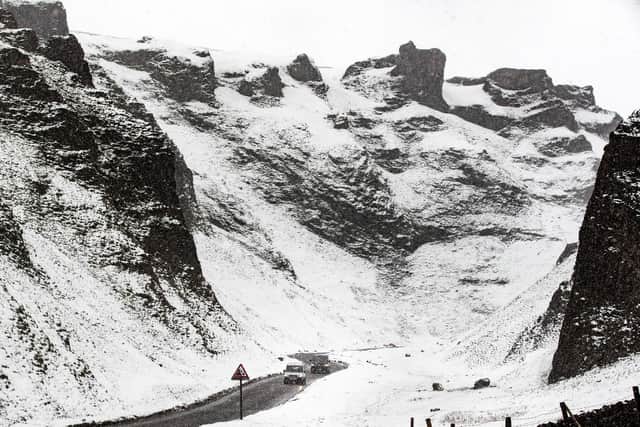 Cars navigate in snowy conditions on Winnats Pass - Danny Lawson/PA Wire
