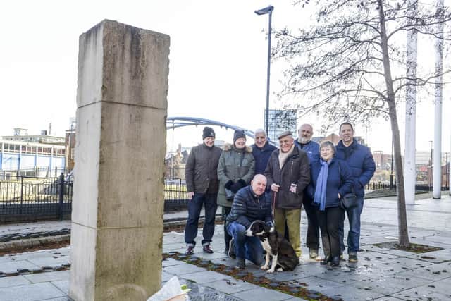 Members of the public alongside the Sheffield Flood Memorial at Millsands in the city to mark the 155th anniversary of the tragedy of 1864