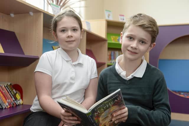 Alfie and Maddie share a book