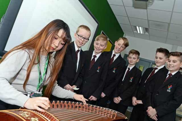 Visitor Ziwei Jin, pictured playing a Chinese Zither, as year seven children look on, during a Chinese music and song class
