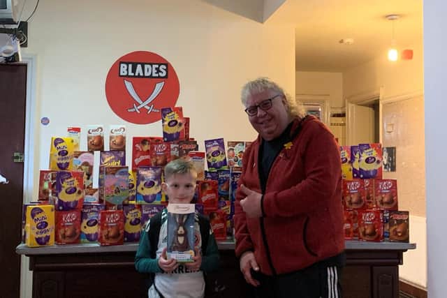 Harri Parker collecting some of the Easter eggs which have been donated from the Cricketers Arms landlord Malcolm Sissons