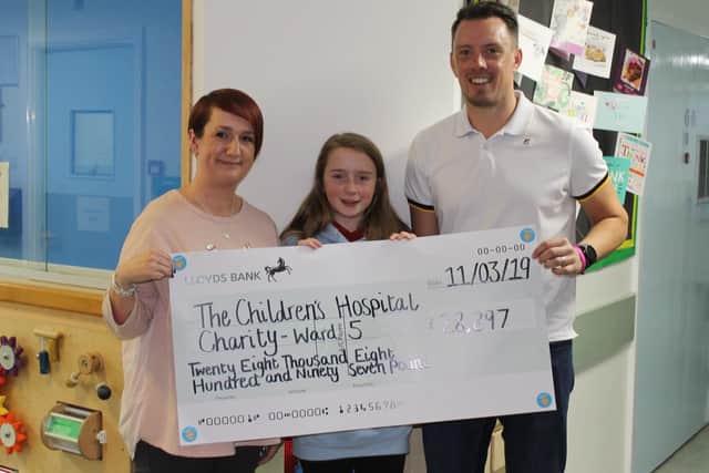 Jack's family - mum Sally, dad Dan, and sister Emily - present their fundraising to Sheffield Children's Hospital