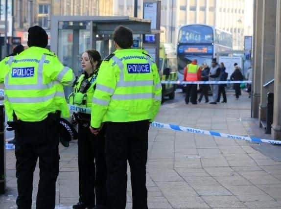 Police officers outside McDonald's in Sheffield city centre following an attack earlier this year (Pic: Chris Etchells)