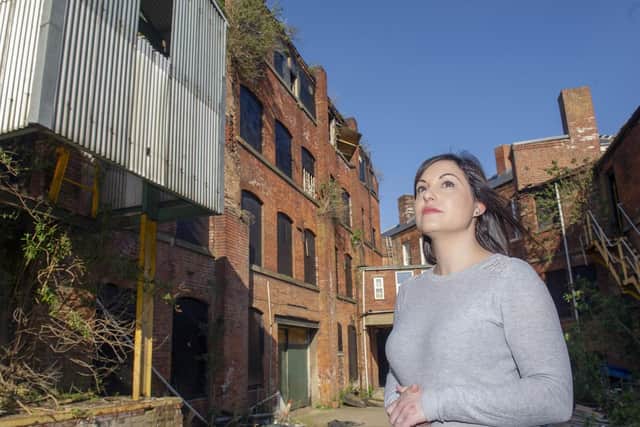 Jenna Al-Kufaishi outside the remaining buildings at the old Lion Works site, which have yet to be developed despite planning permission being granted