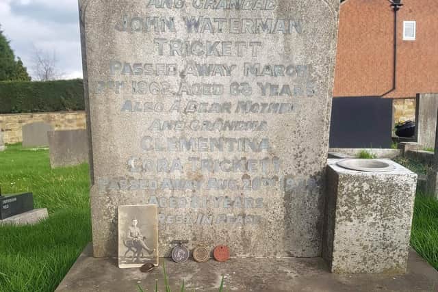 Pte Trickett's grave with his 'lucky penny' and war medals displayed
