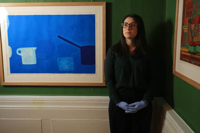 Dr Abi Shapiro with works by William Scott. Picture: Chris Etchells