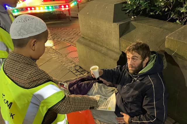 Young volunteers from the As-Salaam Foodbank distribute hot meals in Sheffield city centre