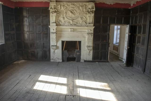 The oak-panelled walls and carved fireplace upstairs at Carbrook Hall