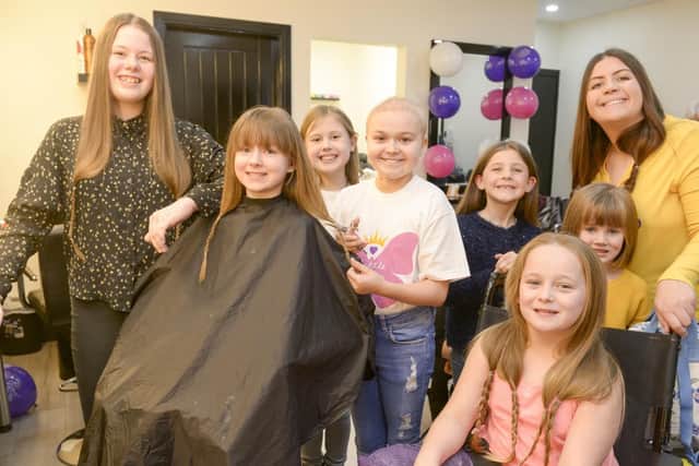 Izzie Hindley who has Hodgkins lymphoma and her pals raising money for Sheffield Childrens hospital by having their hair cut at McQueens in Chapletown
Pictured are Harriet, Amy, Izzie, Poppy, Bea, Katie ,Amy-Leigh, Victoria and Evie with hairdressers Imogen and Hannah