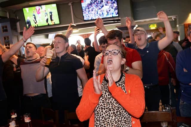 Blades fans celebrate in the Clubhouse on London Road. Picture: Steve Ellis
