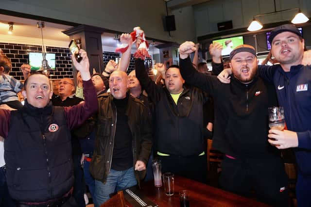 Blades fans celebrate in the Clubhouse, London Road after watching Leeds draw with Villa on TV confirming Sheffield United's promotion to the Premier League. Picture: Steve Ellis