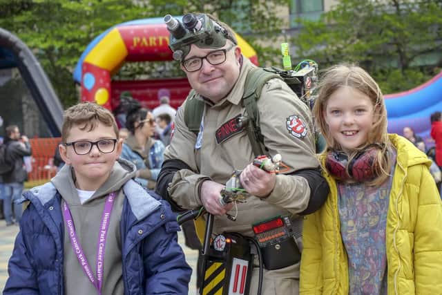 Cash for Kids Superhero Day in the Peace Gardens.Ghostbuster Adrian Finney with Mason Patterson and Madison Bate. Picture Scott Merrylees