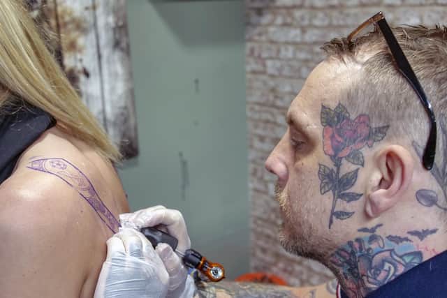 Ben Smalley, who owns Skin Candii tattoo parlour in Woodhouse, inks a Blades-themed tattoo (pic: Scott Merrylees)