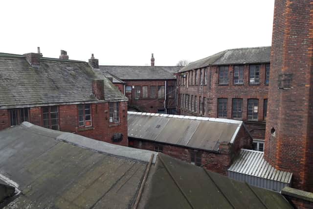 The cluster of Victorian buildings at Portland Works, Sheffield. The chimney, right, now has scaffolding up