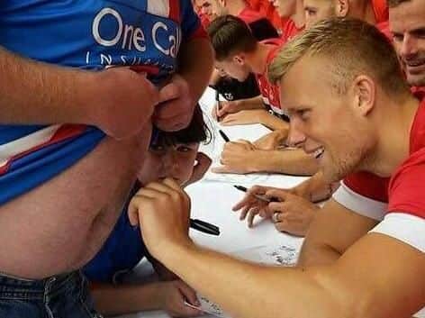 Doncaster Rovers fan Neil Taylor got the signature of now departed striker Curtis Main tattooed onto his stomach.