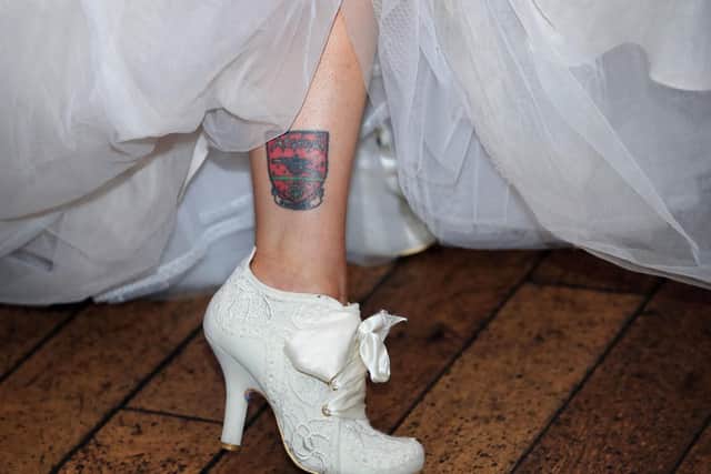 Doncaster bride Nadine Hanlon shows off her Arsenal tattoo on her wedding day.