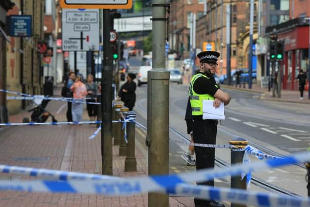A police cordon remains in place on West Street in Sheffield city centre after a man was injured in a collision with a tram last night (Pic: Chris Etchells)