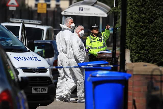 Forensics officers arrive at a property. Picture: Danny Lawson/PA Wire