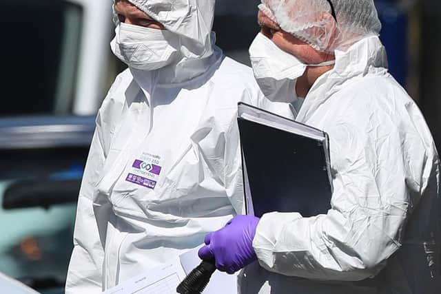 Forensics officers at a property. Picture: Danny Lawson/PA Wire