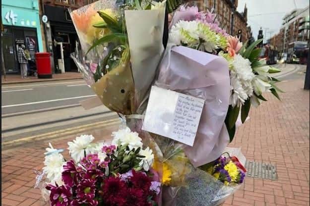 Floral tributes have been left on West Street in Sheffield city centre following a fatal tram collision