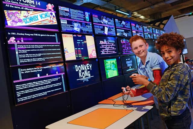 Ryan Johnson and Finley Cocker, both nine, pictured trying out Platform 14, one of two new exhibits currently on at the National Videogame Museum. Picture: Marie Caley