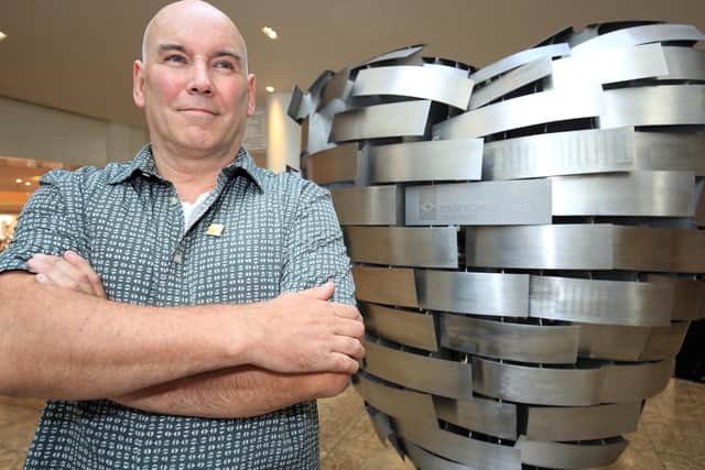 Former steelworker Steve Mehdi in front of the Heart of Steel sculpture at Meadowhall, which he designed