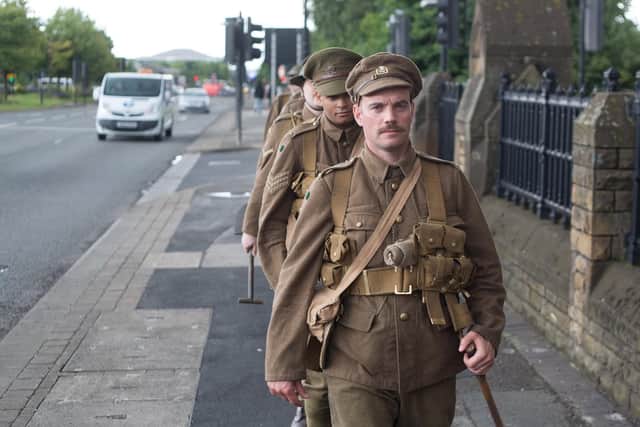 Actors taking part in the World War One 14-18 NOW memorial event We're Here Because We're Here in Sheffield in July 2016