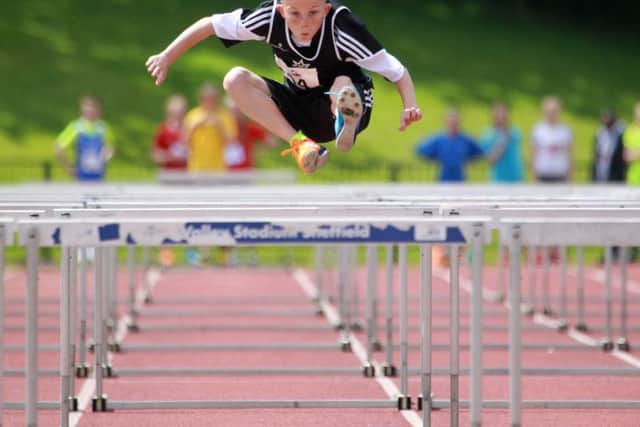 A young hurdler in action during a meeting at Sheffield Hallam University City Athletics Stadium in 2015