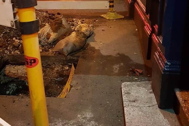 A hole dug by the front door of The Harlequin, May 2017